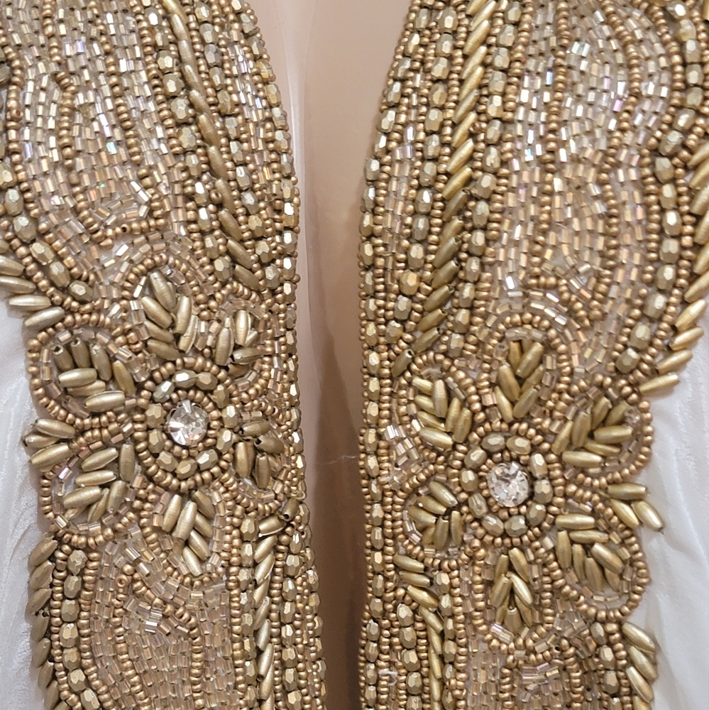 Manish Vaid Embellished Dress, the dress is the color white with gold beading.